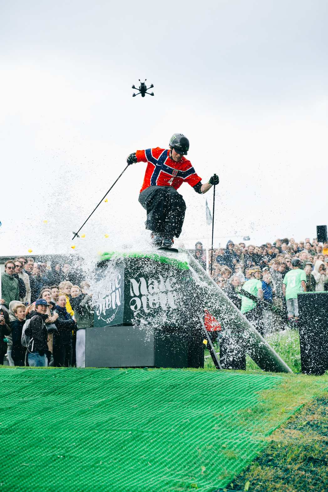Skier jibbing a wet feature on the Neveplast FreeStyle synthetic snowpark surface