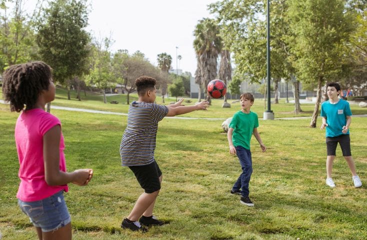 bambini che giocano alla palla in un campo estivo, parole dell'estate in inglese