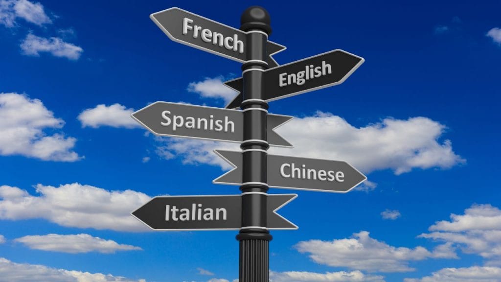 cartelli che indicano in varie direzioni e su ciu ci sono scritti i nomei delle lingue, che cos'è il bilinguismo